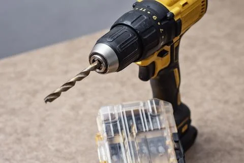 Cordless drill driver with a complete set of drill bits and screwdriver bit.. Stock Photos