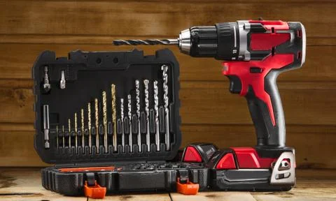 Cordless drill driver in red with rubberized handle in profile with drill bits Stockfoto's