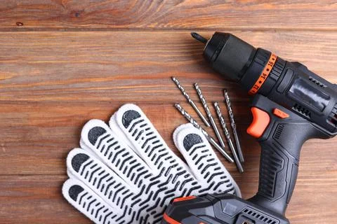Cordless Drill Featuring Various Drill Bits Set Against a Vibrant Blue Stock Photos
