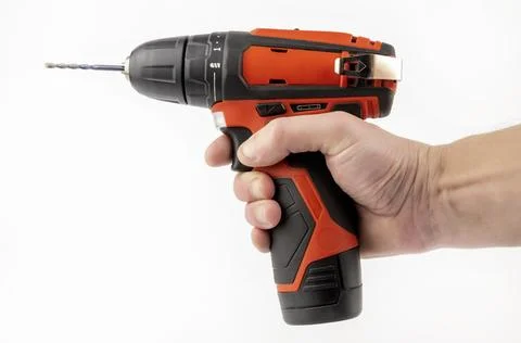 A cordless drill in the hand of a master. The concept of furniture production 스톡 사진