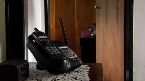 Cordless Home Phone on Table, Quiet Domestic Interior - 4K Stock Footage 326924761