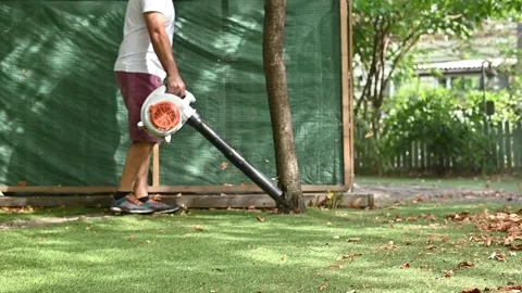 Cordless Leaf Blowers. handheld, cordless, electric leaf blower in a garden. 스톡 동영상 250075264