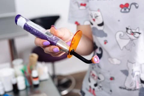 Cordless LED curing light for curing fillings. Dental equipment. Stock Photos