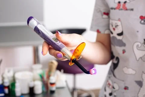 Cordless LED curing light for curing fillings. Dental equipment. Stock Photos