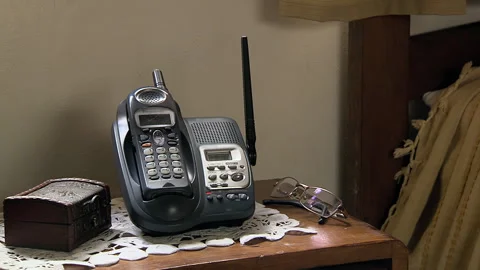 Cordless Telephone on Bedside Table in Elderly Room - Closeup - 4K Stock Footage 287611404
