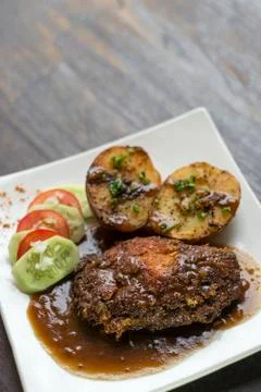 Cordon bleu breaded fried chicken gravy and potatoes meal Stock Photos