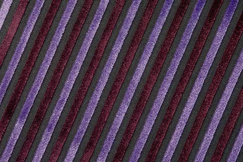 Corduroy background with lines pattern close up. Texture of violet corduroy Stock Photos