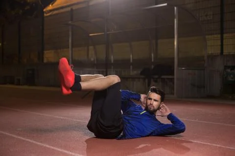 Core abs exercise abs athlete. Night dark. Stock Photos