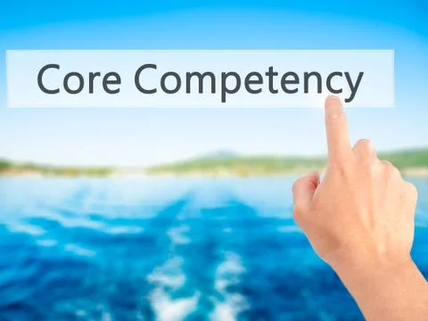 Core Competency - Hand pressing a button on blurred background concept on vis Foto stock