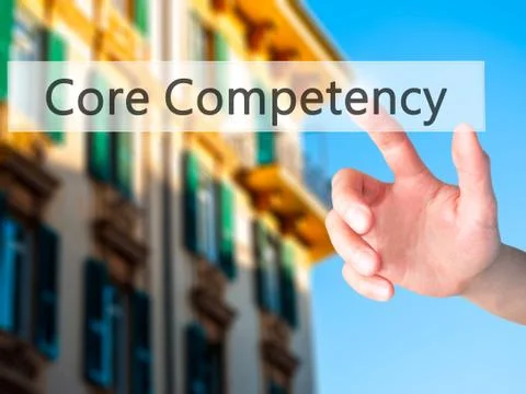 Core Competency - Hand pressing a button on blurred background concept on vis Stock Photos