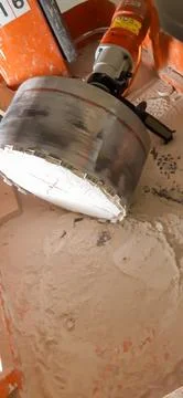 Core drill with masonry still inside the drill bit Stock Photos