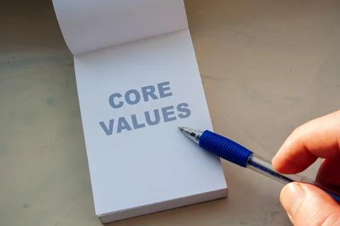 Core values concept written on white notepad page with blue pen pointing at Stock Photos