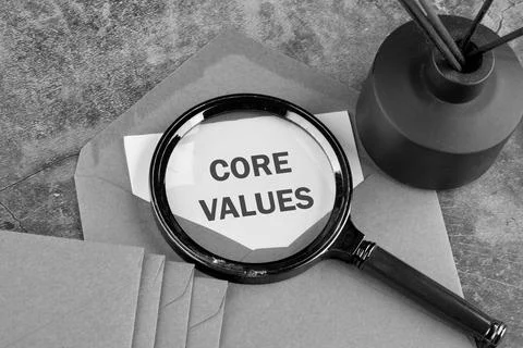 CORE VALUES. ethics concept, text through a magnifying glass on a piece of pa Foto stock