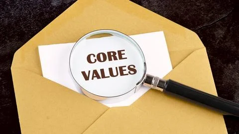 CORE VALUES. ethics concept, text on a white sheet of paper through a magnify Foto stock