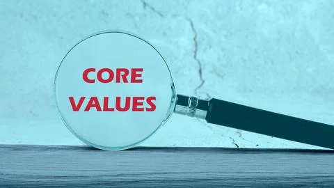 CORE VALUES. ethics concept, text through a magnifying glass on an abstract b Stock Photos