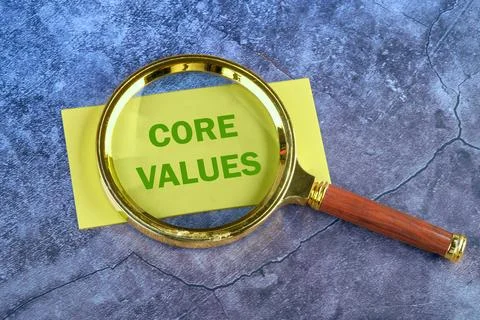 CORE VALUES. ethics concept, text through a magnifying glass to a yellow bu.. Stock Photos
