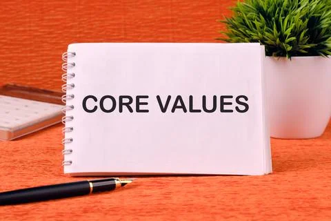 CORE VALUES word written on a blank sheet of notepad, there is a calculator.. Stock Photos