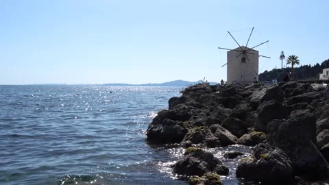 Corfu Greece old Windmill on the Water. Ionian Sea Waves Hitting Rocks on S.. Stock Footage 336595082
