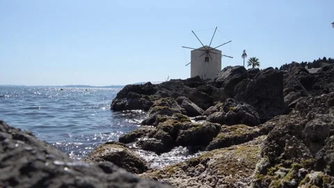 Corfu Greece old Windmill on the Water. Ionian Sea Waves Hitting Rocks on S.. Stock Footage 336595093