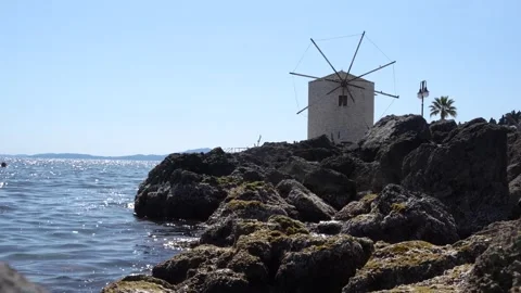 Corfu Greece old Windmill on the Water. Ionian Sea Waves Hitting Rocks on S.. Stock Footage 336595098
