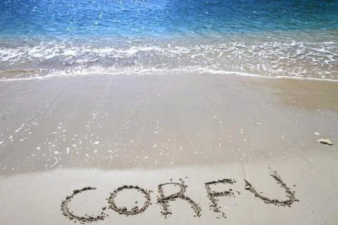 Corfu written on sandy beach Stock Photos