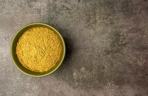 Coriander Powder from a flat lay angle with a dramatic dark background. Stock Photos