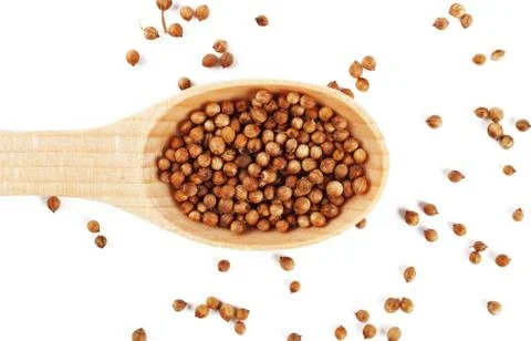 Coriander in a wooden spoon on a white background, isolate Foto stock