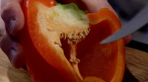Coring half of a red pepper Stock Footage 8573592