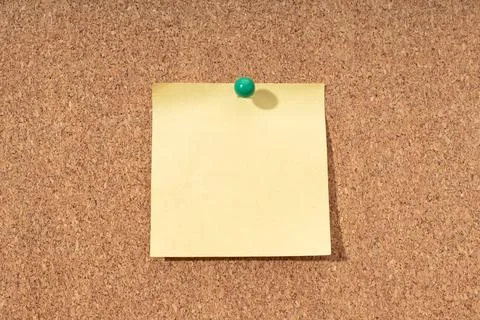 Cork board with blank yellow note for adding text. Mock up Stock Photos