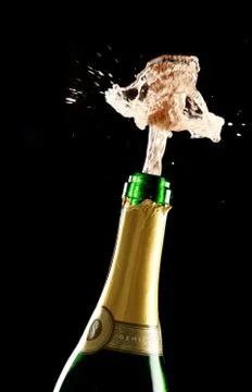 Cork Exploding Out Champagne Bottle Stock Photos