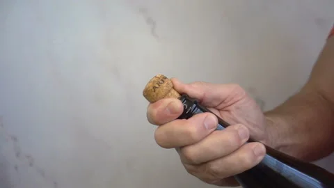 Cork flies in slow motion from a bottle of champagne. Stock Footage 199680659