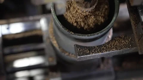 Cork Granules Pouring From Green Drum Mixer at Baseball Factory Stock Footage 339736388