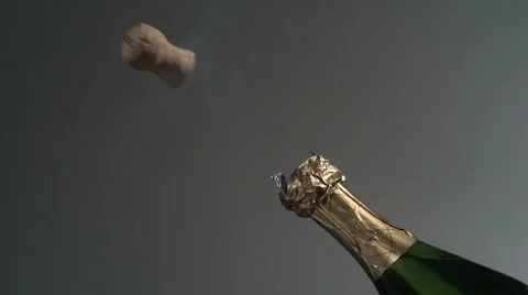 Cork pops off champagne bottle in super slow motion. Shot with Phantom camera at Stock Footage