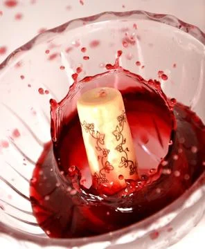 Cork in red wine splashes Stock Photos