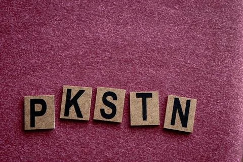 Cork Scrabble Tiles Displaying Random Letters on Red Fabric Background Stock Photos