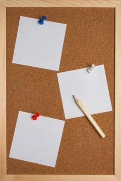 Corkboard with white sheets for notes and a pencil Stock Photos