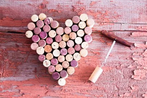 Corks in Heart Shape and Bottle Opener on Table Stock Photos
