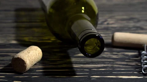 Corkscrew, cork, bottle and glass of red wine on a wooden table Stock-Footage 68788093