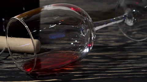 Corkscrew, cork, bottle and glass of red wine on a wooden table Stock-Footage 68836242