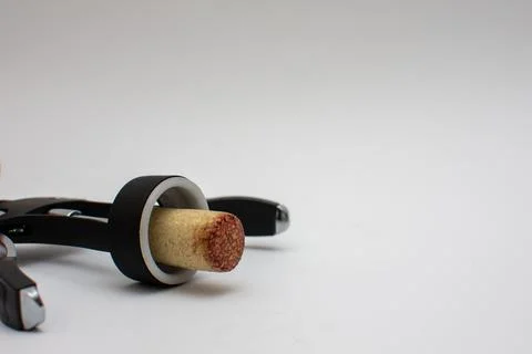 Corkscrew with a cork from an open bottle of red wine Stock Photos