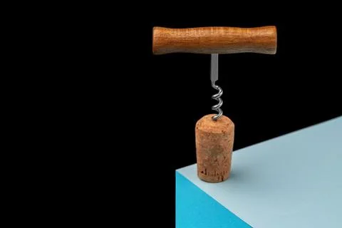 Corkscrew with a cork for wine on a three-dimensional plane. On a cube on a Stock Photos