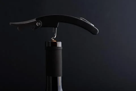 Corkscrew opening a bottle of red wine Stock Photos