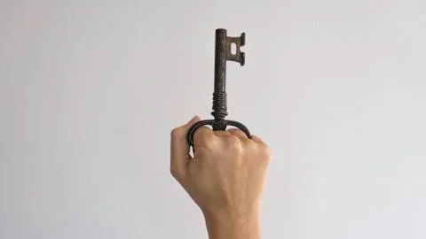Corkscrew for opening bottles in the form of a key in a woman's fist. Foto stock
