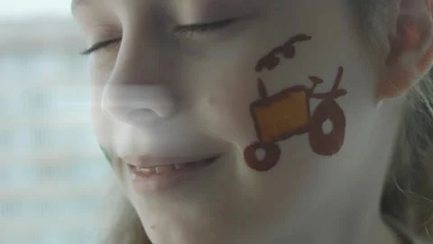 Corn and tractor drawings on the face of a cute cheerful girl. Agriculture Stock Footage 256038915