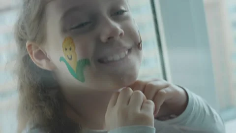Corn and tractor drawings on the face of a cute cheerful girl. Showing heart Stock Footage 256039497
