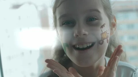 Corn and tractor drawings on the face of a cute cheerful girl. Showing emotion Stock Footage 256039586