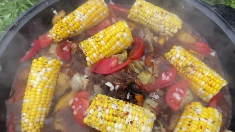 Corn with beef and vegetables. Soup with Tomato, red pepper cooked on hot coals Stock Footage 218646129
