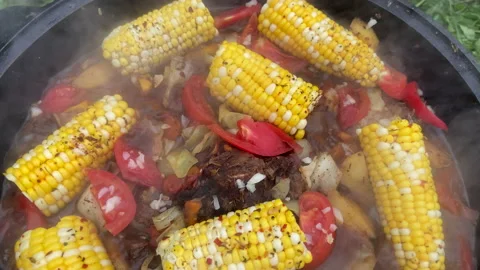 Corn with beef and vegetables. Soup with Tomato, red pepper cooked on hot coals 스톡 동영상 218646303
