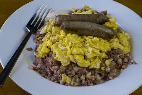 Corn beef hash top with scrambled eggs and sausage Stock Photos