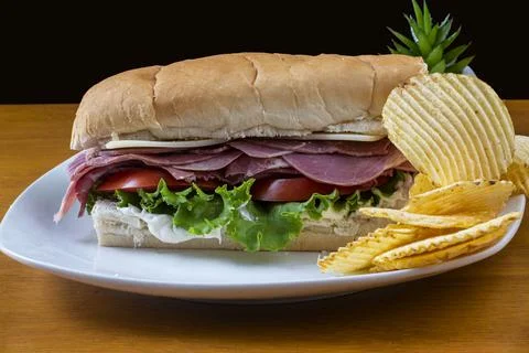 Corn beef sandwich  with a side of potato chips Stock Photos